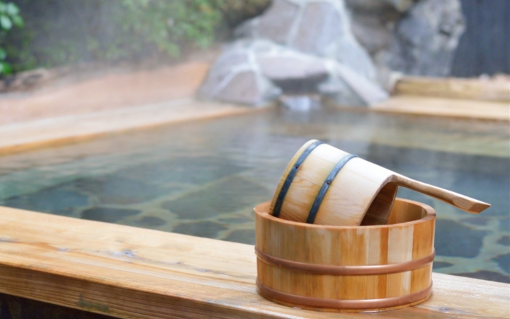 A steaming Japanese onsen invites relaxation and peaceful enjoyment.