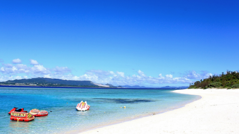 Crystal-clear waters and white sandy shores define the serene Okinawa coast.