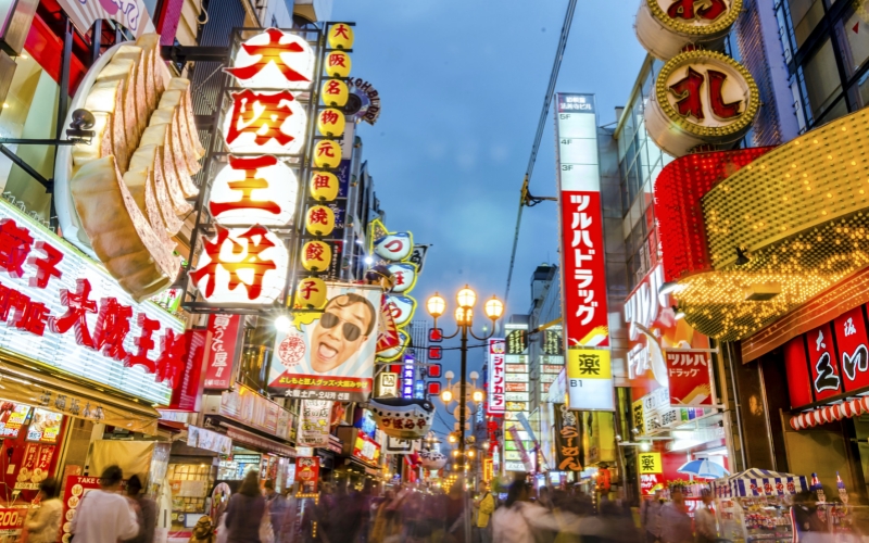 Osaka's bustling commercial streets are filled with neon lights, street food, and vibrant energy.