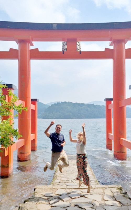 Jumping for joy at the iconic lakeside torii of Hakone Shrine