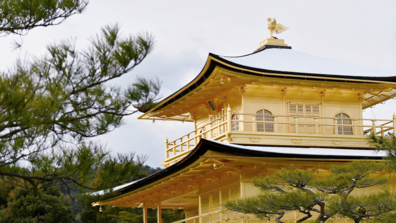 Kinkaku-ji stands serene under its winter dusting of snow, its golden walls shining softly against the cold Kyoto sky.