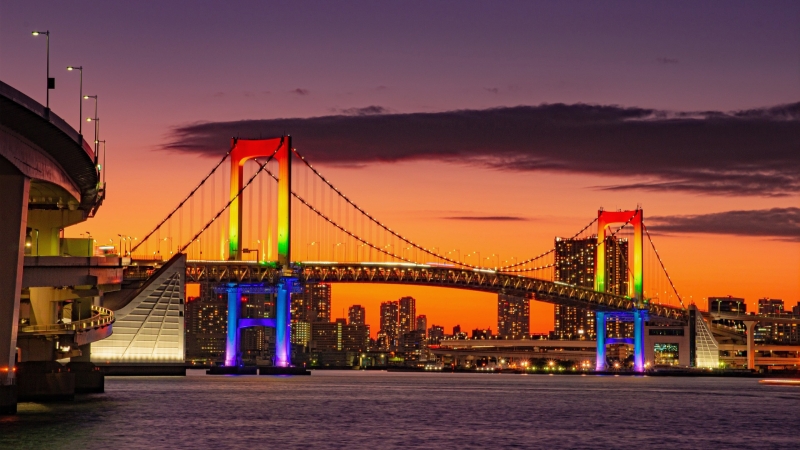 Rainbow Bridge glows over Tokyo Bay at sunset, marking a calm end to a March day.