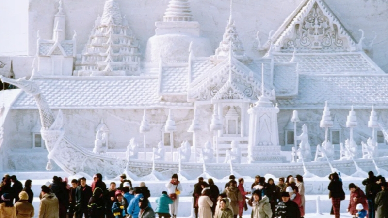 Towering snow sculptures rise above the crowd at the Sapporo Snow Festival