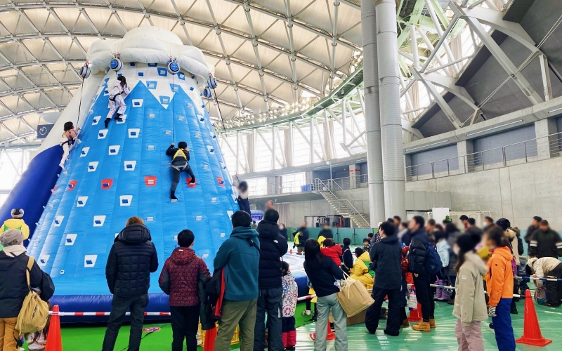 Families enjoy indoor winter activities at the Tsudome venue during the Sapporo Snow Festival.