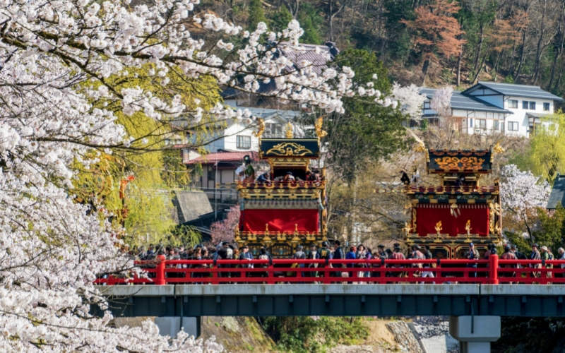 The Takayama Spring Festival in April features colorful parades with ornate floats and cherry blossoms.