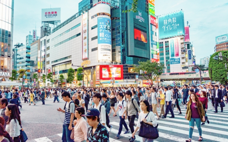 Shibuya Crossing with large crowds on day time