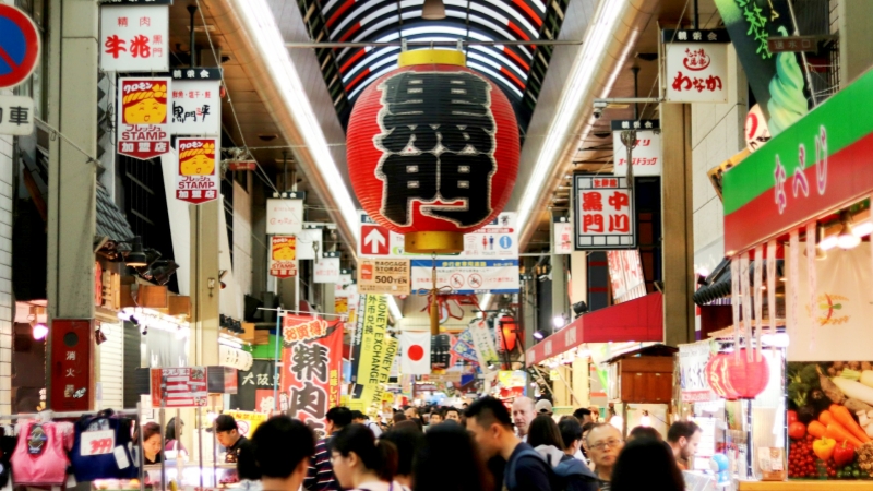 Exploring the vibrant Kuromon Ichiba Market, Osaka's iconic covered foodie haven.