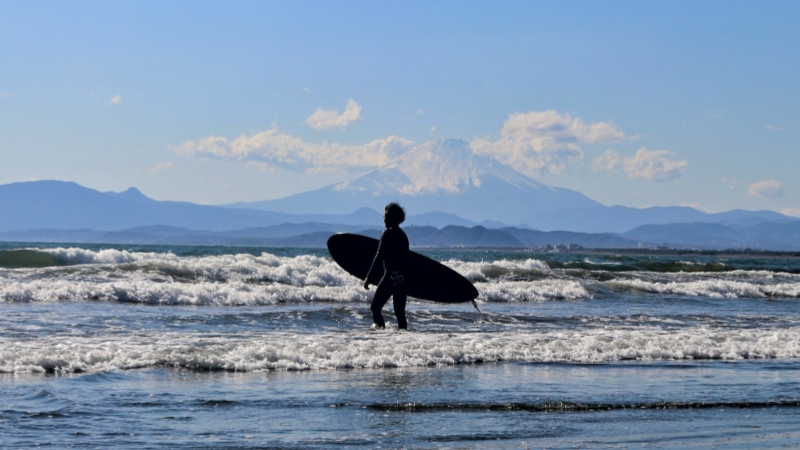 A man is surfing at the seaside of Enoshima