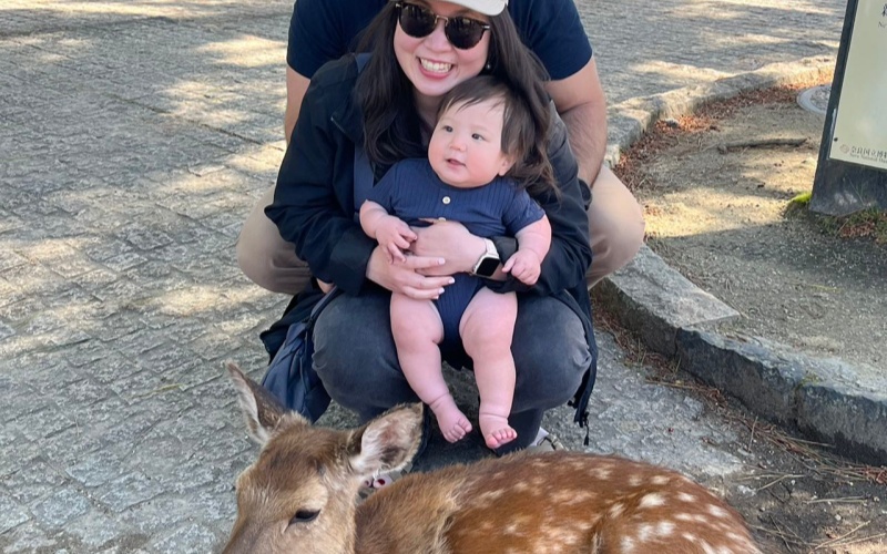 Family with Baby Feeding Deer at Nara Park Japan