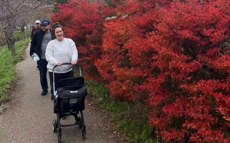 A Family Strolls Along a Paved Autumn Trail in Japan