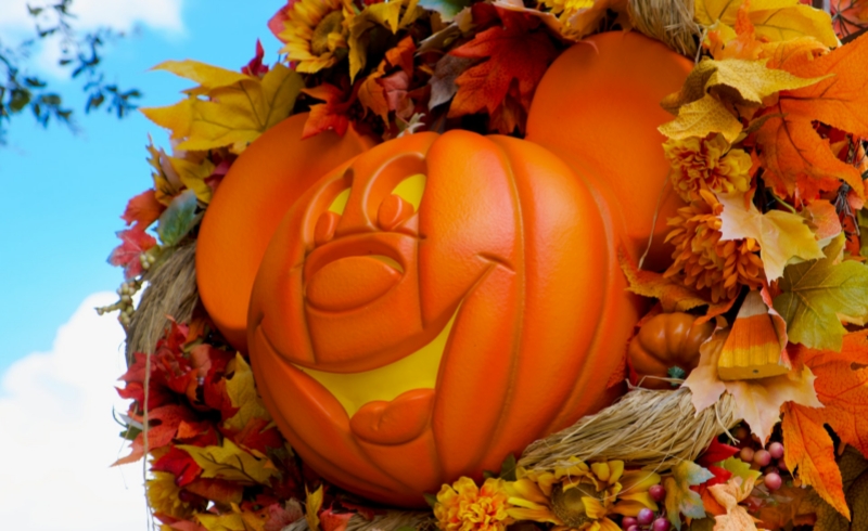 A cheerful Mickey pumpkin surrounded by autumn leaves captures the festive Halloween spirit at Tokyo Disney Resort.