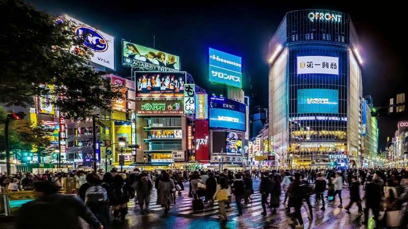 A vibrant night view of Shibuya Crossing filled with crowds and neon-lit energy in the heart of Tokyo.