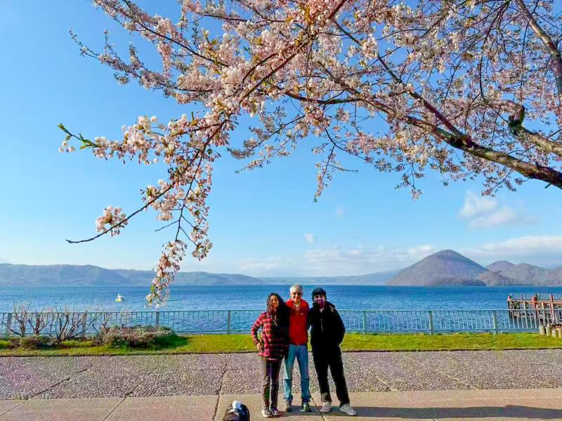 A Family Enjoying Japan's Cherry Blossom Season with Scenic Landscapes and Memorable Moments beyond the Busiest Tourist Areas.