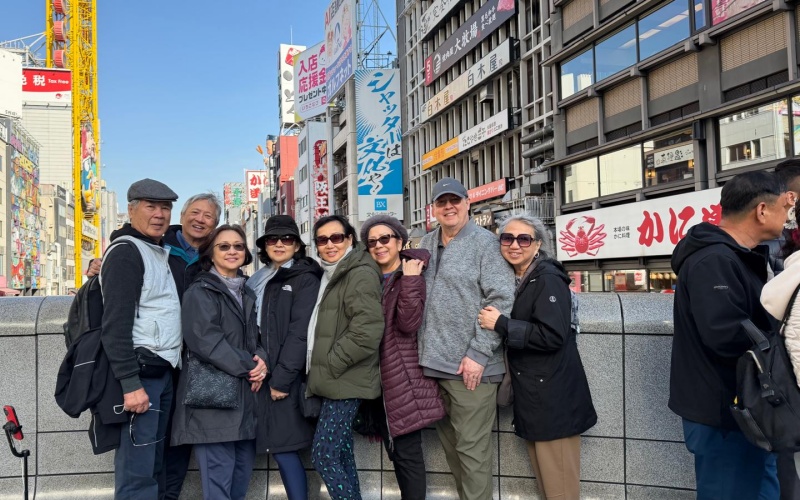 Smiling Travelers Exploring Osaka’s Iconic Dotonbori