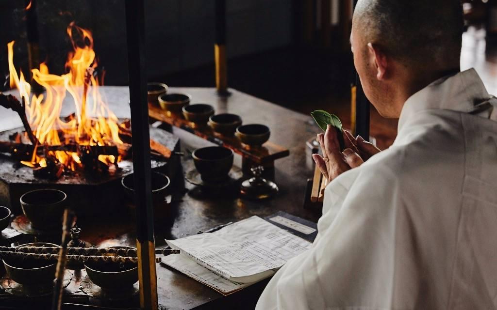 A Buddhist monk performs a sacred morning fire ritual during an exclusive Koyasan temple stay